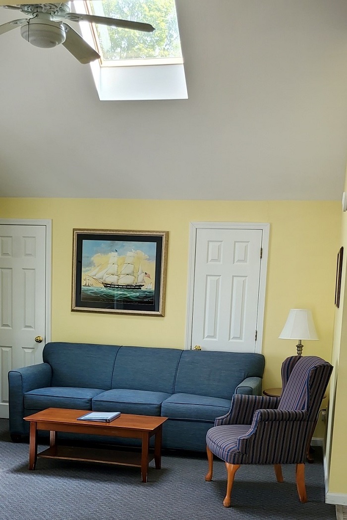The living room's skylight and ceiling fan keep the room bright and comfortable.