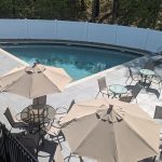 A closer aerial view of the pool, patio and seating.